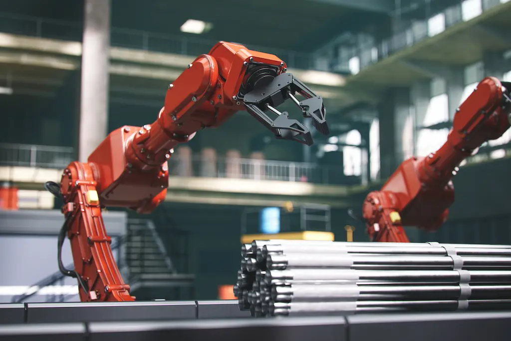 Robotic arms handling metal components in an automated manufacturing facility